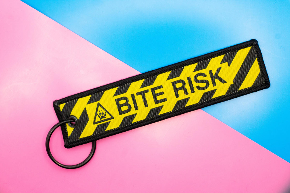 Bite Risk Embroidered Jet Tag | 5 Inch Woven Double Sided Keychain